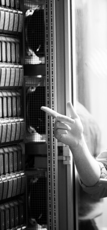 Black and white photo showing a man pointing at the server