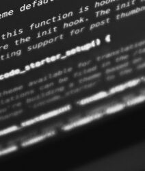 Black and white photo showing code on a computer screen